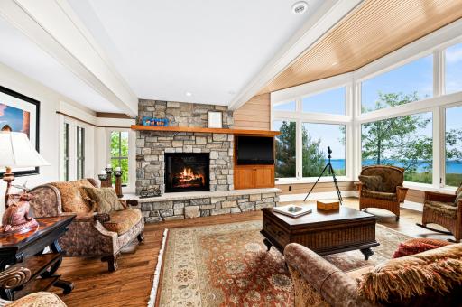 Main Level: Living Room is main gathering area in home and features a beautiful stone hearth with gas fireplace, cherry mantel and tv cabinet