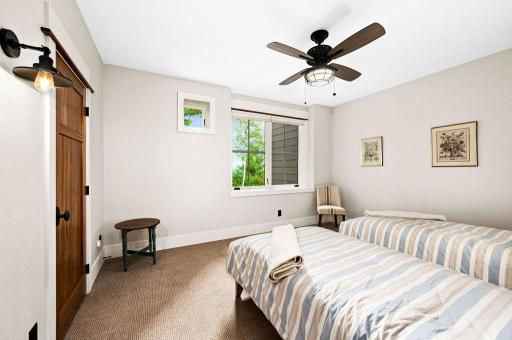 ...Ceiling Fan and large Window with view of the Woods