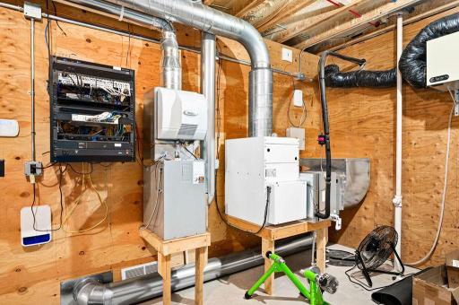Lower Level: Mechanical/Storage Room with new boiler for in-floor heat (2023), water heater, A/C, Aprilaire Humidifier, Air Exchange System, Electrical Panel, Culligan Drinking System and Home Electronics