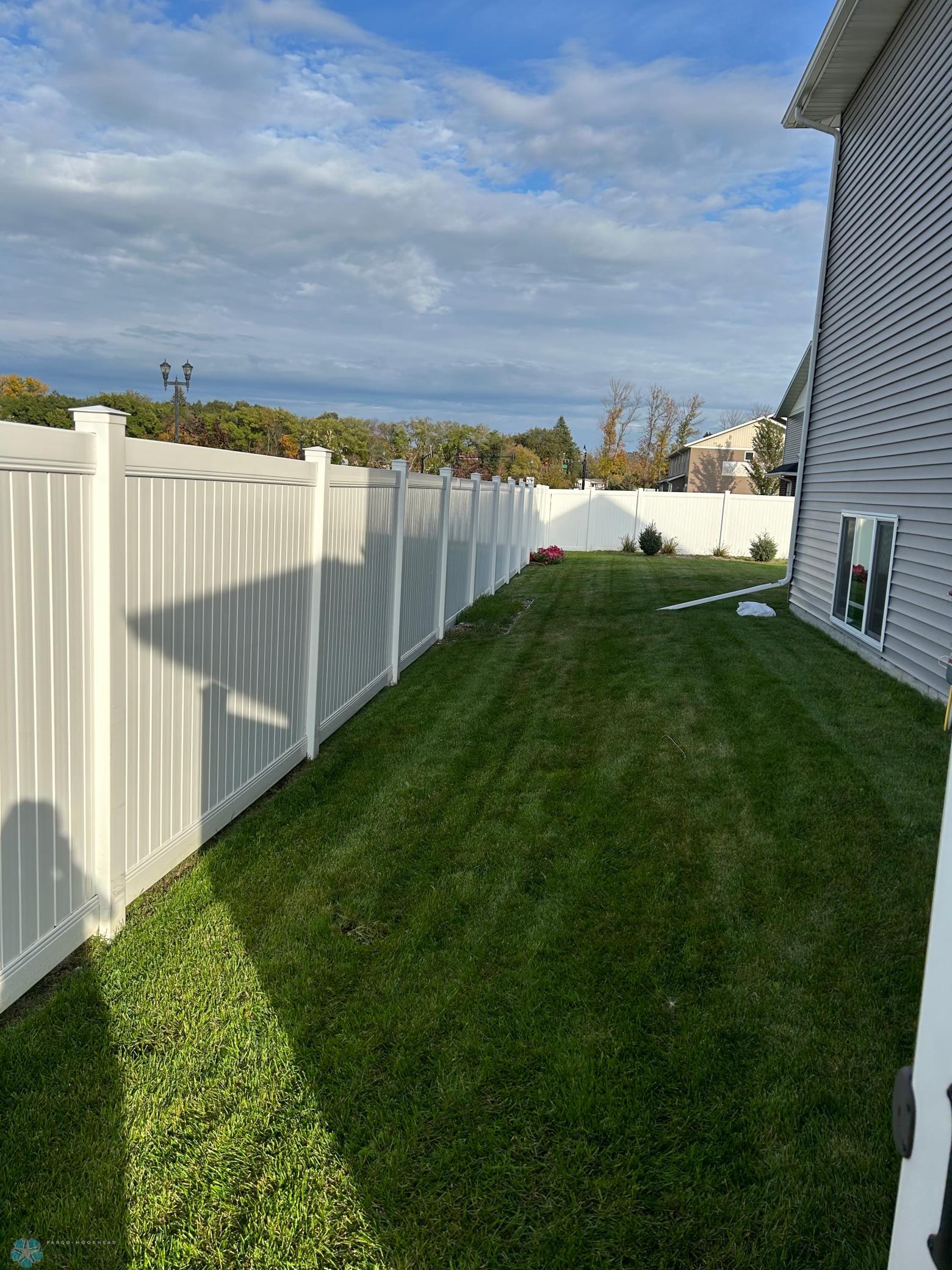 fully fenced yard with sprinkler system