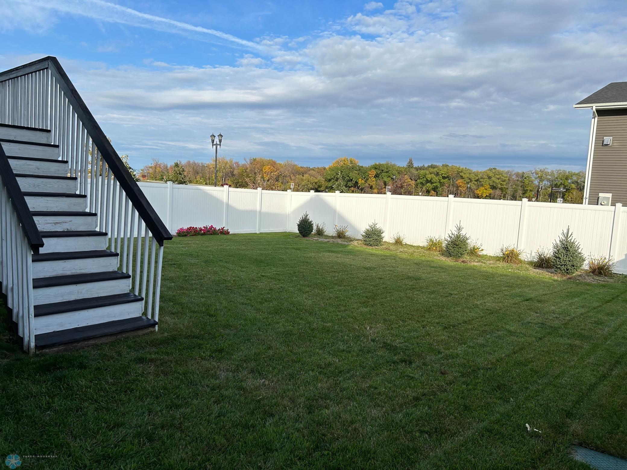 fully fenced yard with sprinkler system