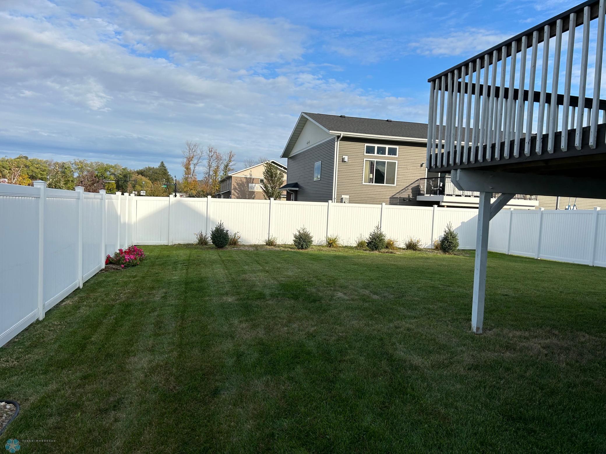 fully fenced yard with sprinkler system