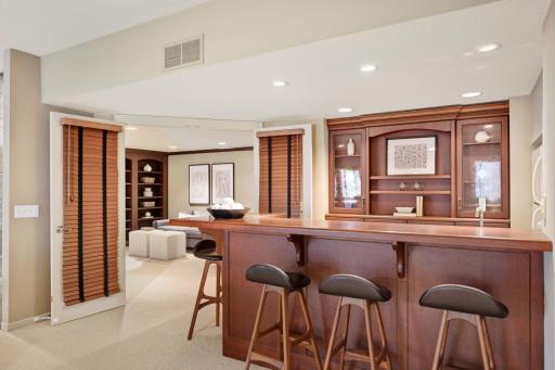 Wet Bar area with sink and full refrigerator.