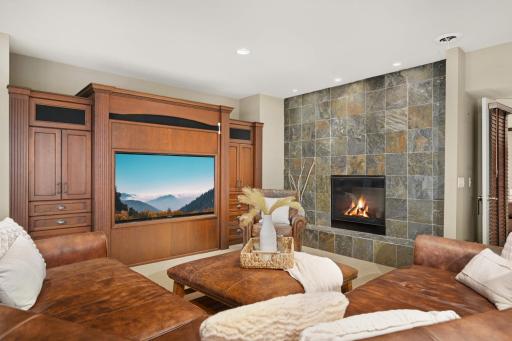 Double-sided fireplace with stone wall and hearth.