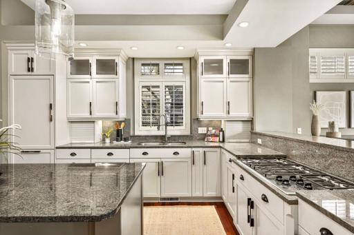 Custom enameled cabinetry including glass fronts.