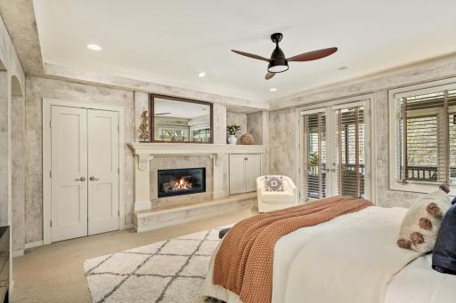 Primary bedroom with Gas fireplace, custom mantle, and hidden TV frame.