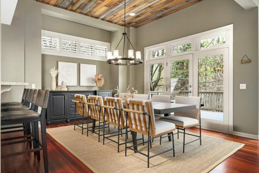 Reclaimed wood ceiling, alcove and transom windows across both dining room walls.