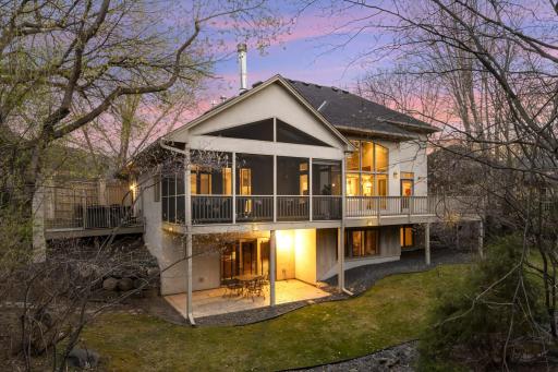 Large Vaulted screened Porch with Trex flooring above private stamped concrete Patio walkout.