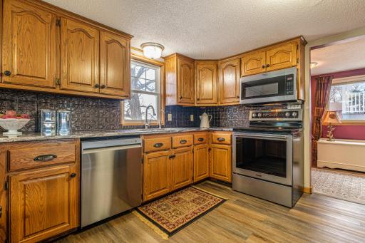 Kitchen features granite countertops (2020) S.S. dishwasher (2024), and LVT flooring (2023).
