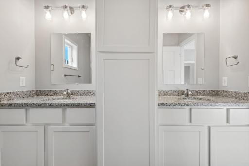 The owners bathroom includes a double vanity with beautiful white enameled cabinets, granite countertops, stunning walk-in tiled shower, and tiled floors. Photo of 4831 Education.