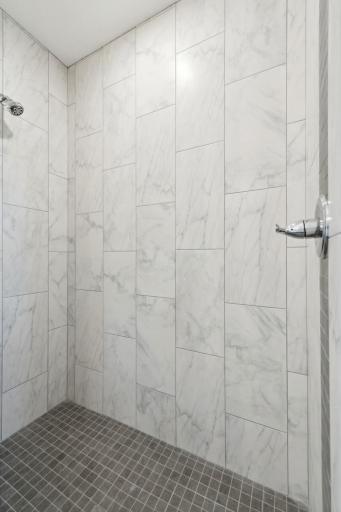 Owner's private bathroom offers a well designed and beautifully tiled walk-in shower. Photo of 4831 Education.