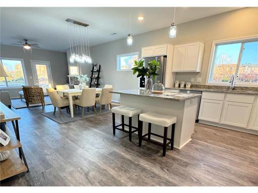 Gorgeous open design with great natural light, fireplace, soft close cabinets, granite countertops, stainless steel appliances including gas stove, and a center island with breakfast bar, and pantry! Photo from model at 4928 Education.
