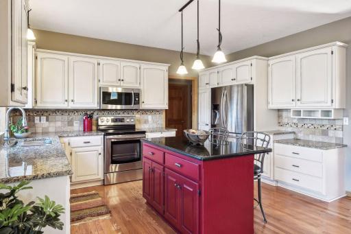 Stylish kitchen island design w/ modern kitchen island. Granite countertops! Abundance of cabinetry.