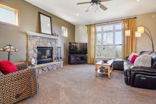 Cozy, ML family room with stone, gas fireplace and large windows. High ceilings throughout main level.
