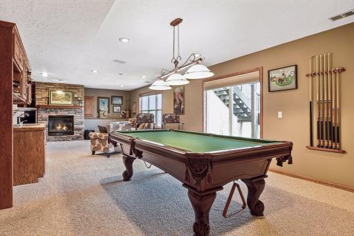 Spacious amusement room and walkout to private backyard.