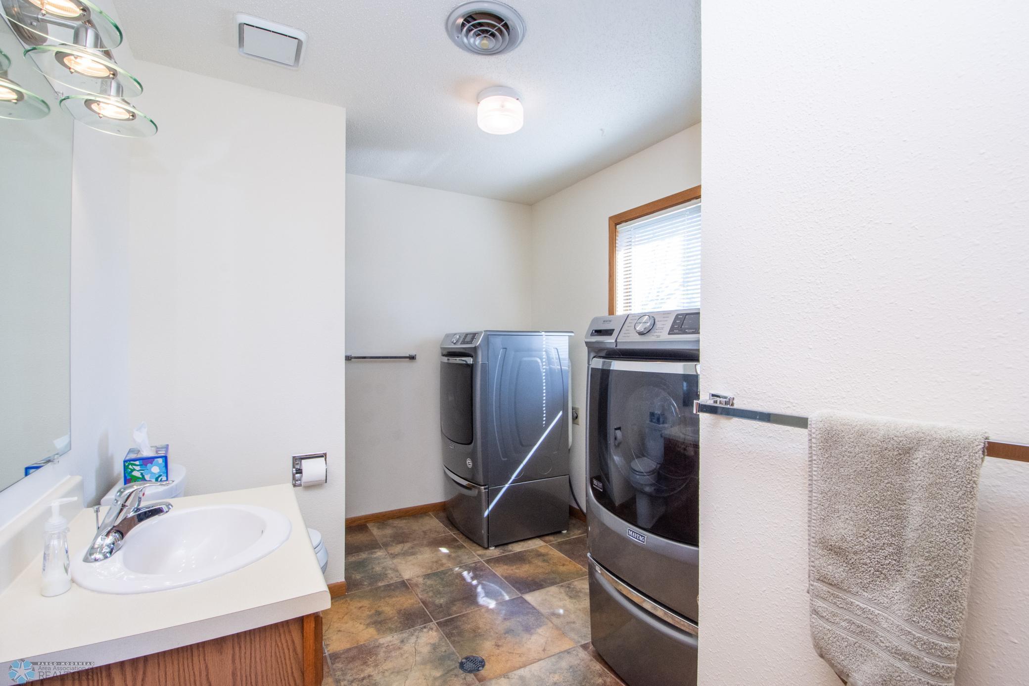 main floor 3/4 bathroom and laundry-heated tile floors