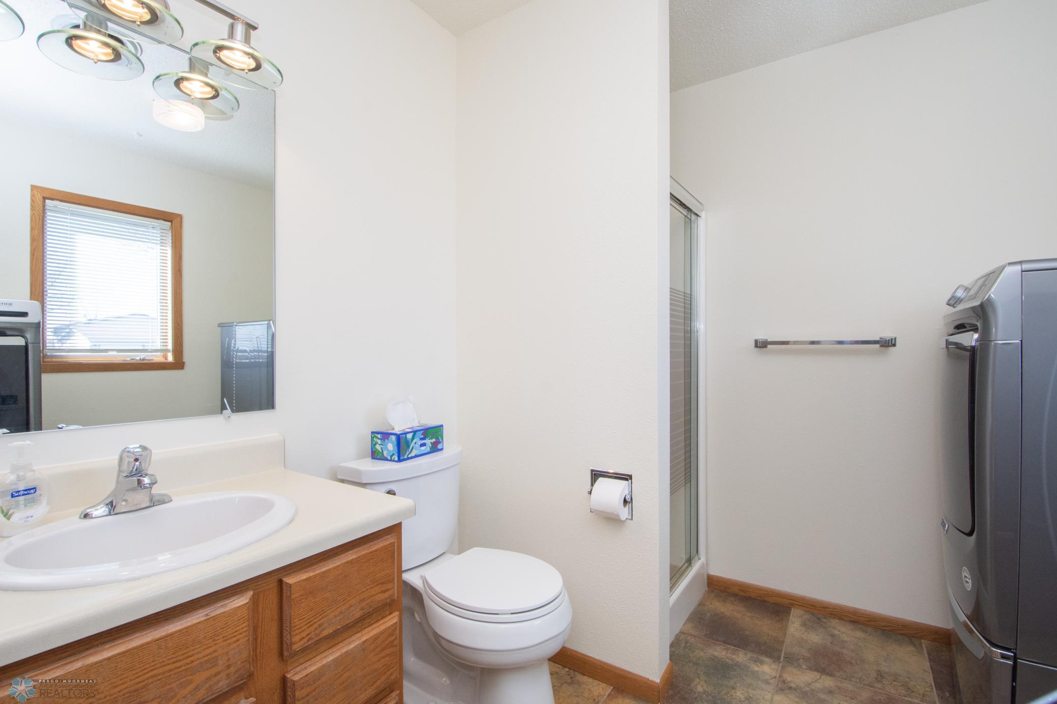 main floor 3/4 bathroom and laundry-heated tile floors
