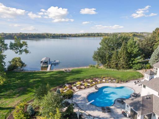 Experience the ultimate in outdoor living with newly updated pool, patio, custom gas firepit and landscaping, where lush greenery and creative design elements create a serene oasis.