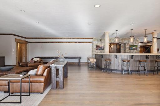 Welcome to the entertainer's paradise on the lower level, where every detail is meticulously crafted to ensure endless enjoyment and celebration with direct access to the pool area to encorporate the outdoors.