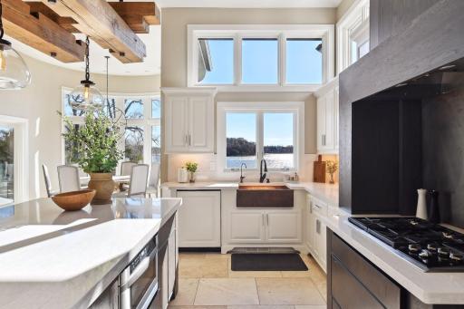 Adorned with high-end appliances and a captivating custom wood hood, all complimented by enchanting views of the lake.