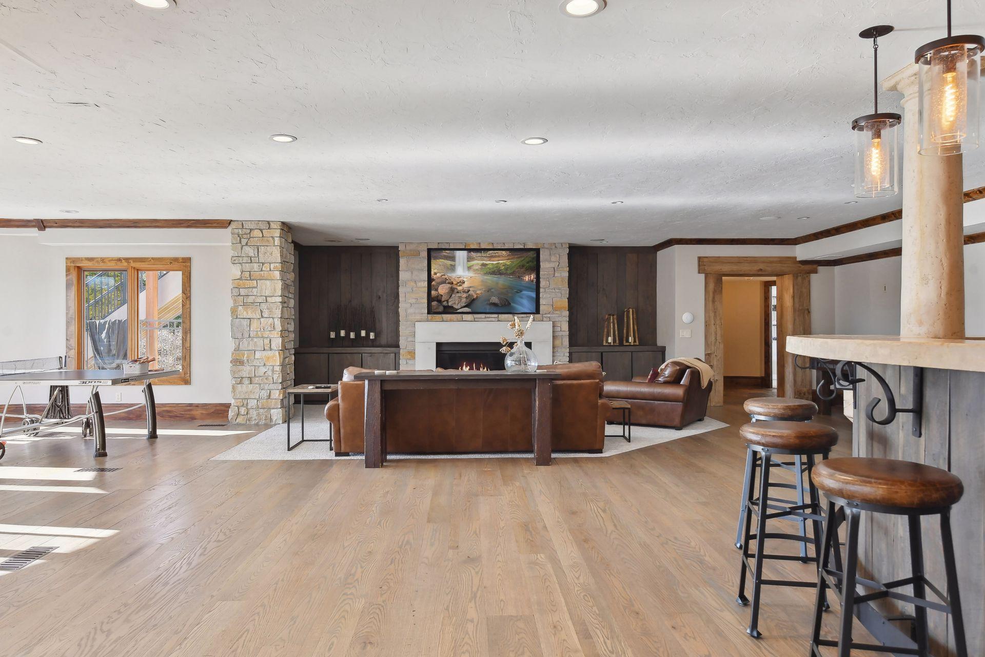 Indulge in leisure and entertainment in the spacious lower level family room, featuring game room and captivating stone bar!