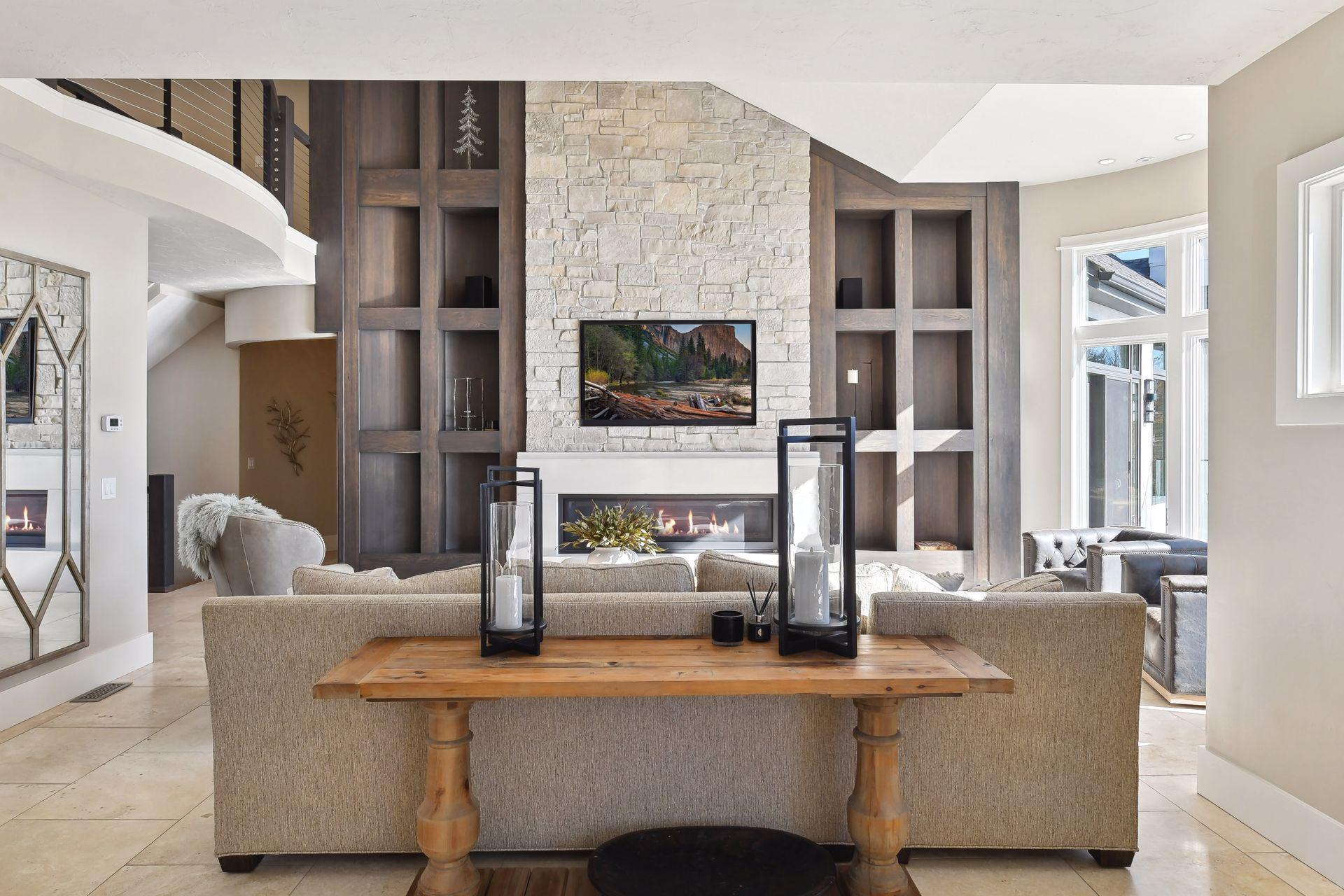 A sleek stone linear fireplace and custom surround create a cozy yet sophisticated ambiance perfect for relaxation and gatherings.