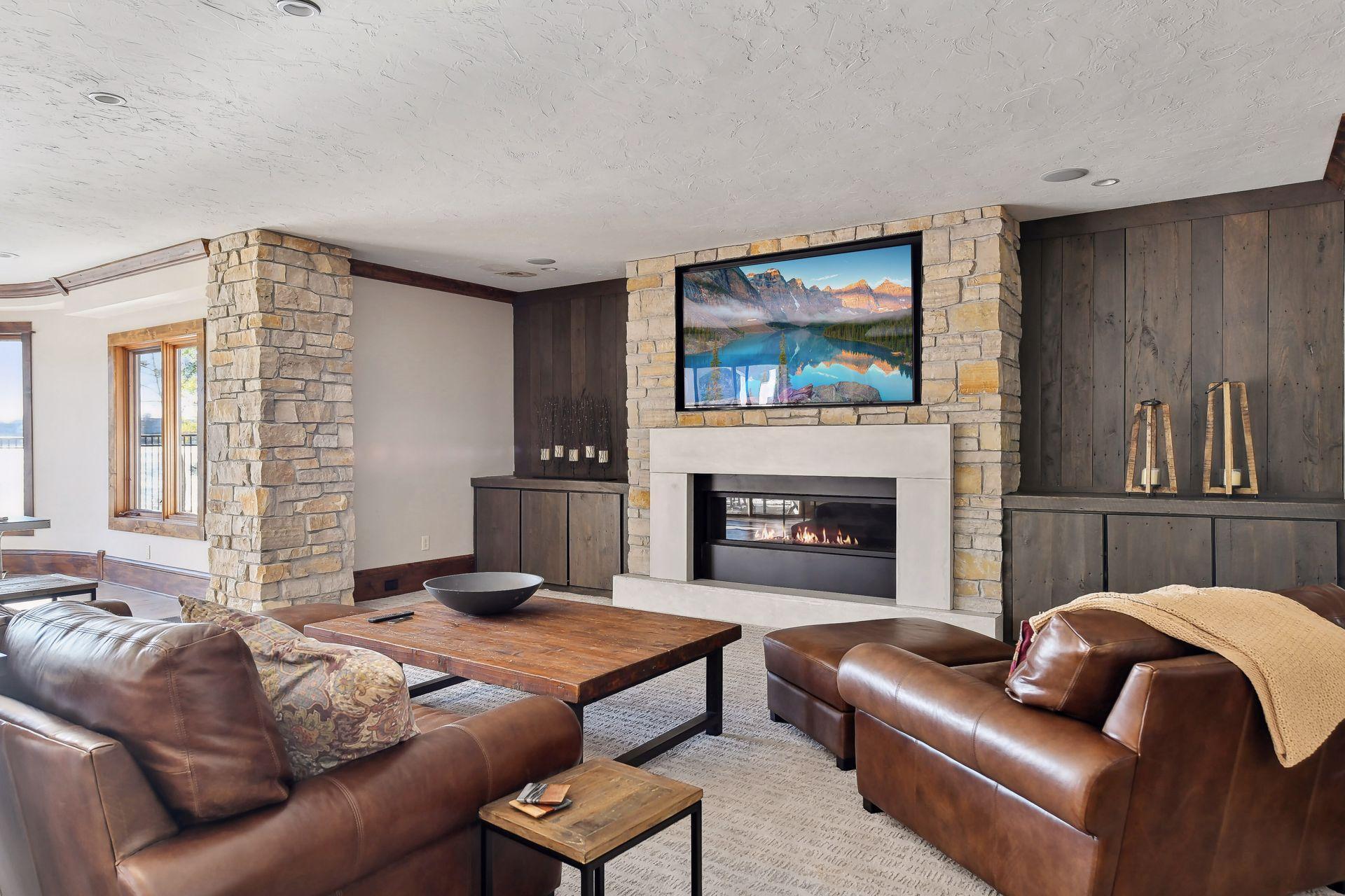 Unwind in the cozy family room adorned with stone accents and custom fireplace.