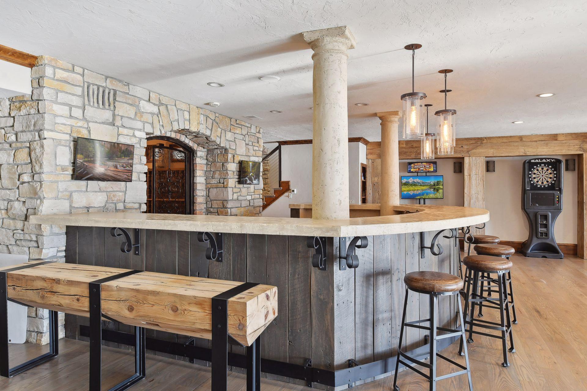 Elevate your entertaining experience with stunning stone wall bar where laughter and camaraderie are sure to flow freely amidst the stylish ambiance.