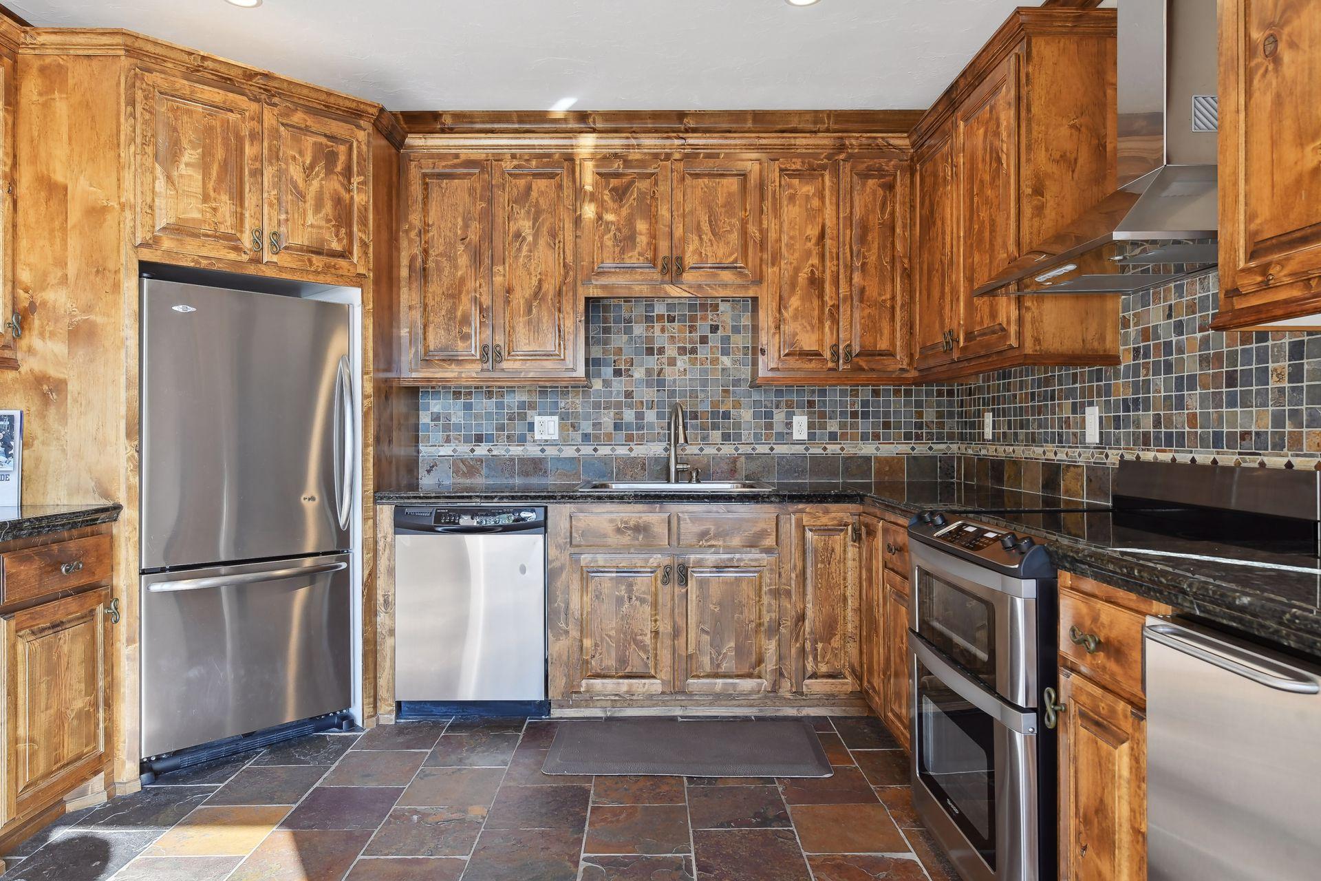 Experience the convenience of a second kitchen located off the pool area and lake, providing easy access to refreshments and snacks while you soak up the sun.