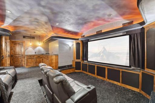 Plush seating, snack bar and surround sound create an ideal home theater experience.