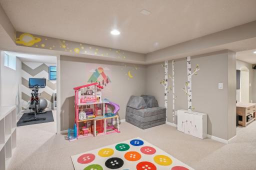 An adjacent playroom is perfect for the kid's toys or a great hobby studio space.