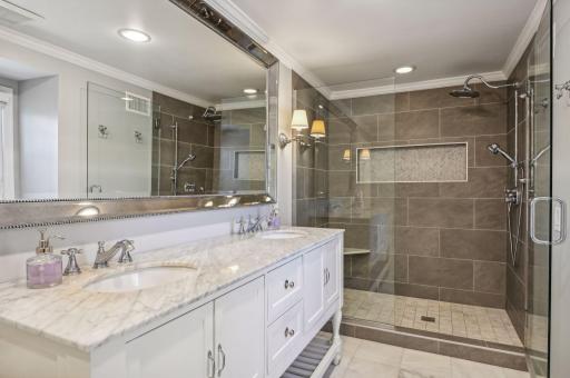 Updated owner's bath with remodeled walk-in shower, double sinks, and heated floors.
