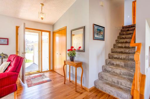 Inviting foyer with vaulted ceilings and a spacious coat closet.