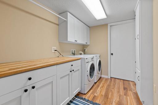 Bright and clean lower level laundry room with access to additional storage room.