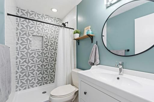Beautiful updated primary bathroom with walk-in shower, accent tile and large vanity.