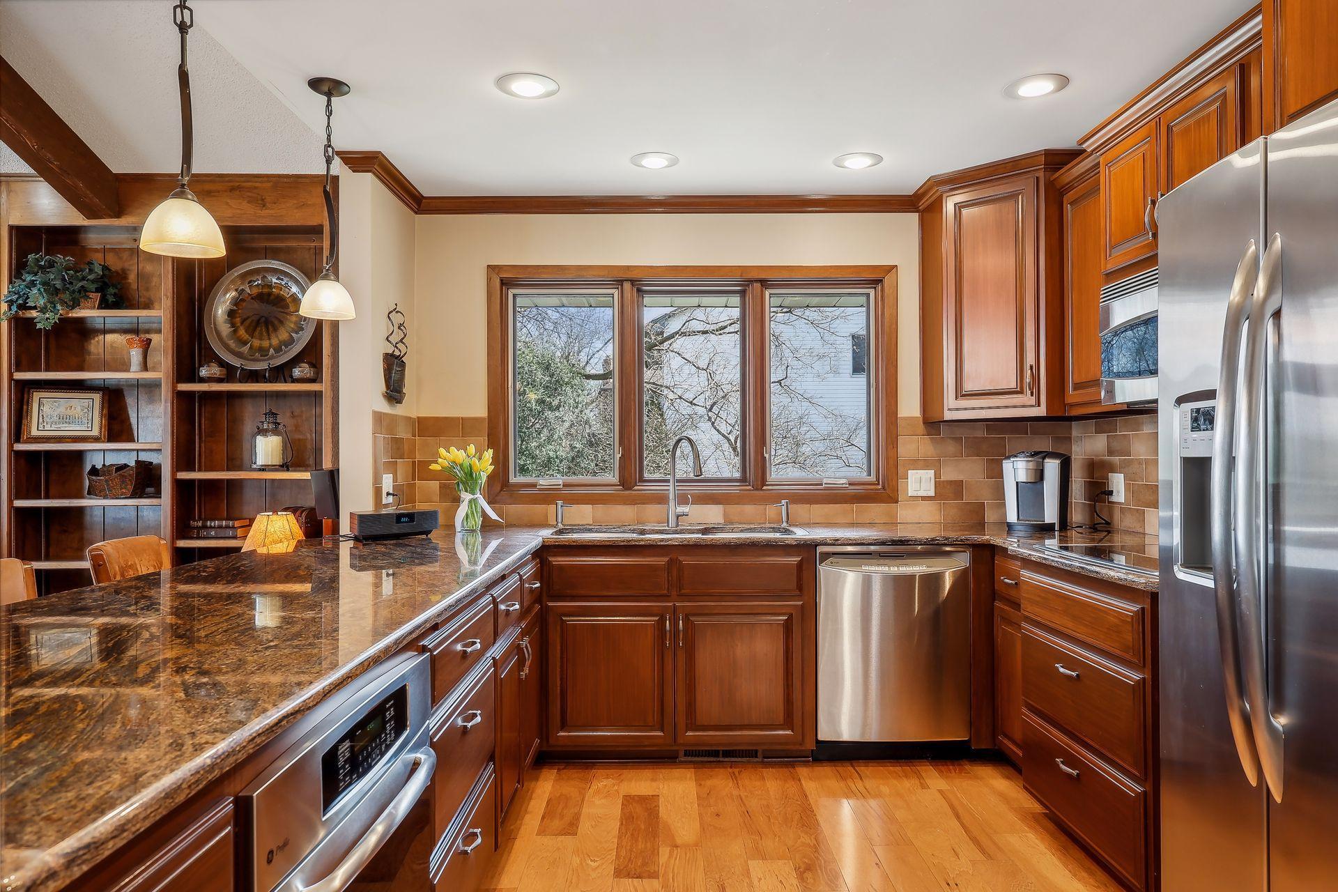 Stunning kitchen with custom cabinets, SS appliances, breakfast bar, coffee bar and more