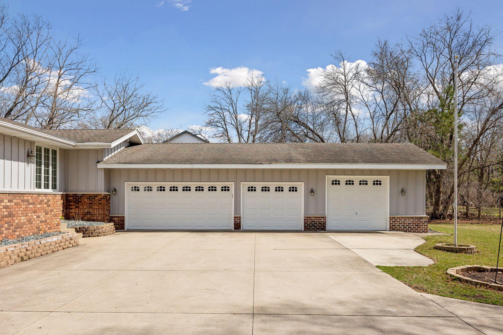 3 Car attached garage with 7' doors and oversized 4th stall workshop with 8' door