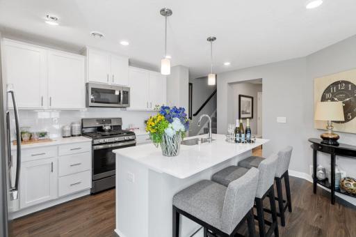 (Photo of a decorated model, actual homes finishes will vary) (Photo of decorated model, actual home's finishes vary) Thoughtfully-designed with a combination of functionality and modern design, this kitchen space is sure to impress.