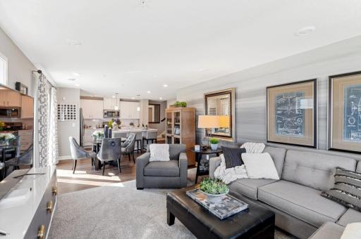 (Photo of decorated model, actual home's finishes vary) The main level seamlessly transitions from room to room while maintaining an open-concept layout throughout.
