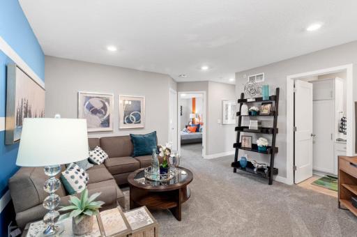 (Photo of a decorated model, actual homes finishes will vary) Located on the upper level, this perfectly sized living space has enough room for a desk, television and seating for all. Plus, it is just steps away from the three bedrooms.
