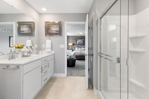 (Photo of a decorated model, actual homes finishes will vary) An extension of the owner's suite, this private and spacious bath contains a double-vanity, a linen closet and a shower.