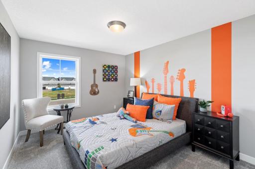 (Photo of a decorated model, actual homes finishes will vary) The second generously sized upper level secondary bedroom with a spacious closet.