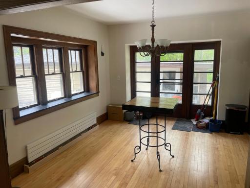 Dining room with triple bay window and large windowed rear entry. Efficient European style radiators replaced cast iron throughout home.