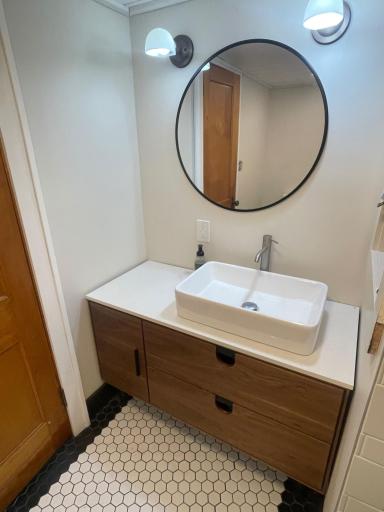 Updated lower lever 3/4 bath with new tile, fixtures, walnut vanity and shiplap ceiling.