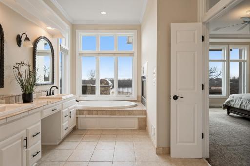 In the ensuite you'll find dual vanities, a walk-in shower, jetted tub with breathtaking views, & heated floors. Unwind after a long day with soothing bubbles & this spectacular view.