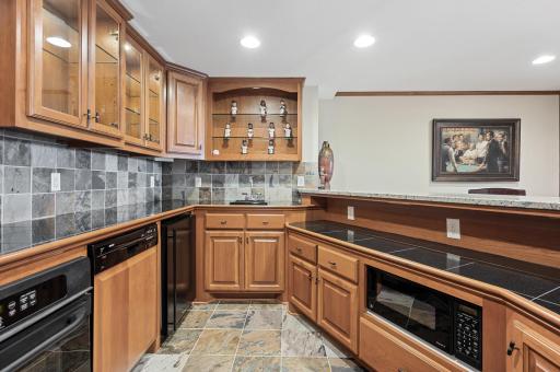 Well equip with sleek countertops, beverage refrigerator, dishwasher, oven, and microwave.