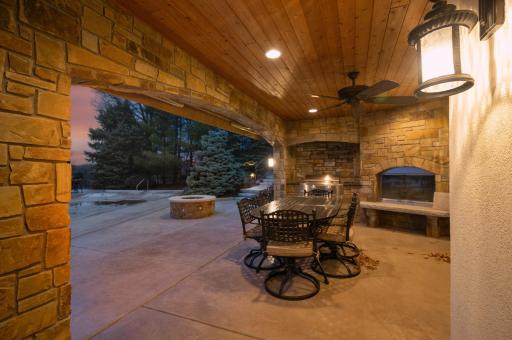 Whether you're cooking up a delicious meal, gathering around the fire for warmth and conversation, or simply relaxing in the open-air enclosure, this patio is a delightful retreat that seamlessly blends indoor comforts with outdoor charm.