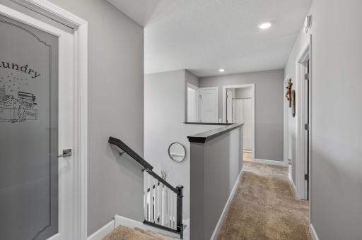 top of the stairs, 2 beds to the right, full bath straight ahead and another bedroom to the left of the bath. Laundry room is to the very left and the primary is directly behind
