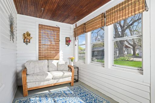 Another charming porch/sunroom off the back of the house overlooking the large backyard