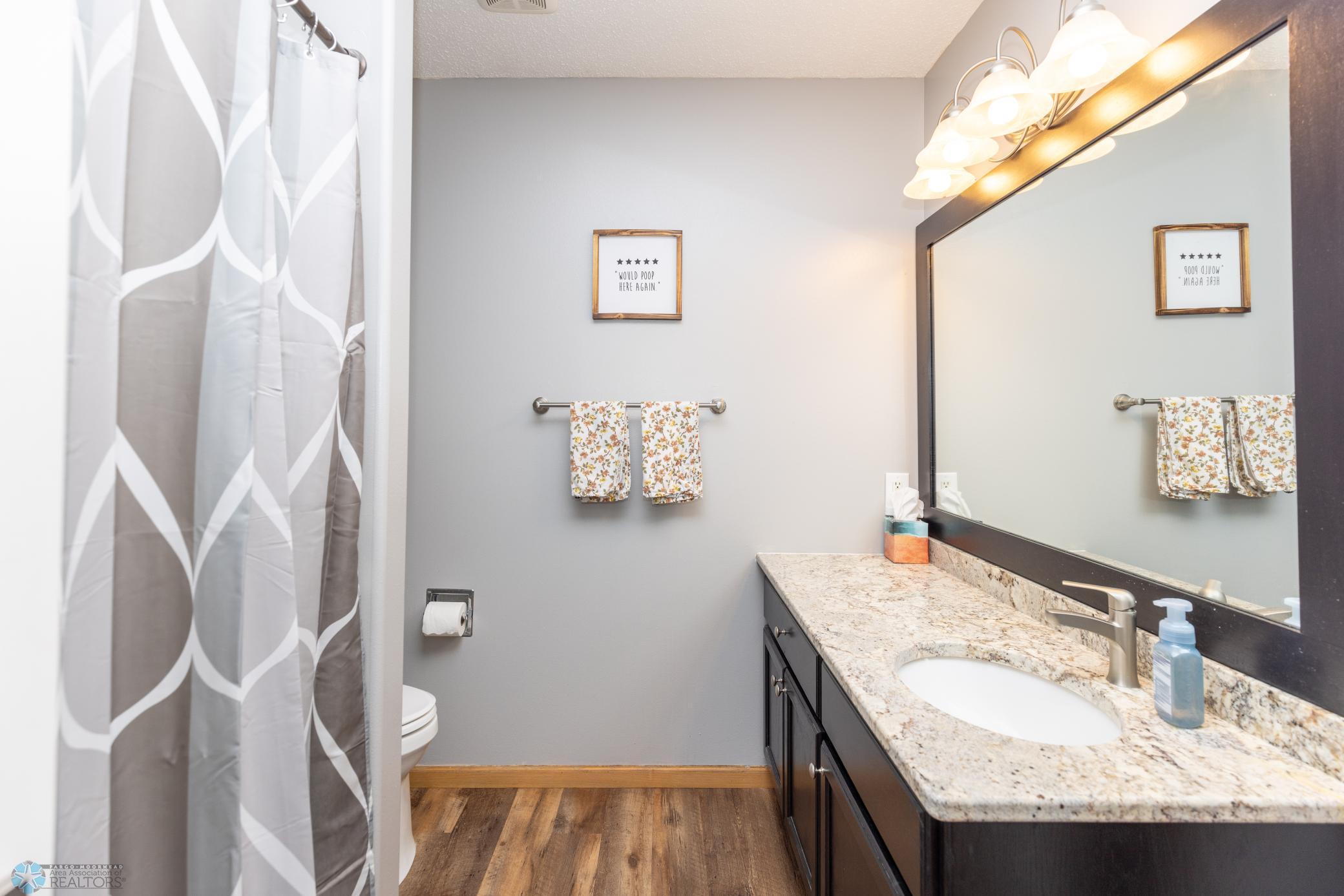 Hollywood bath with granite countertop.